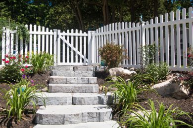 Stone Steps Leading Up To White Picket Fence