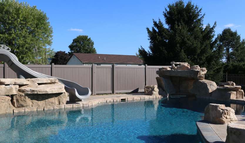 Brown privacy fence around pool 