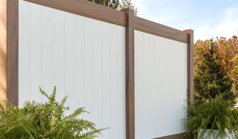 White and brown privacy fence made of vinyl materials