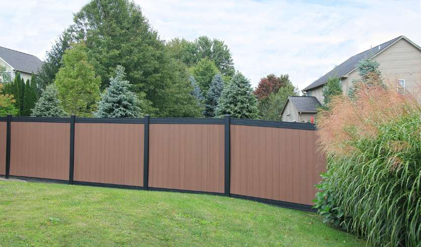 Brown vinyl fence panel with black trim around border