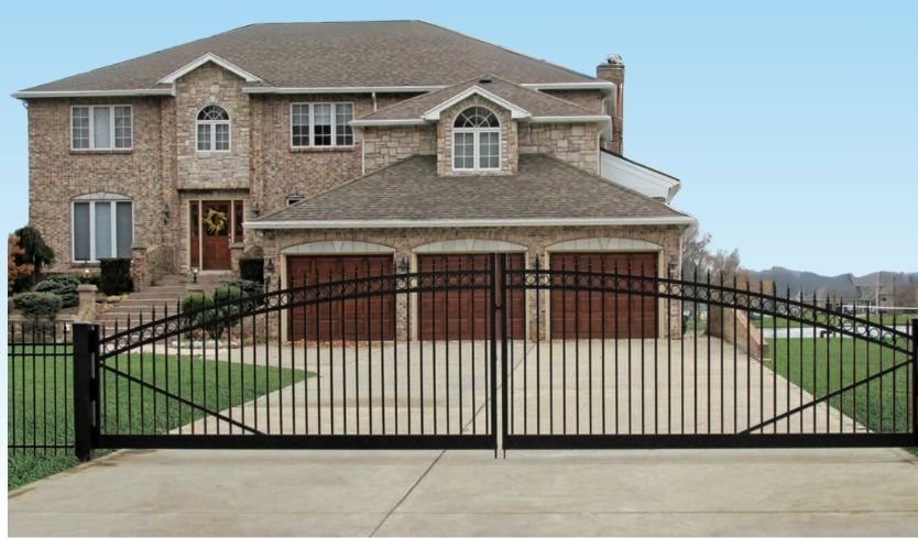 large home and blue sky with Fence and driveway gate