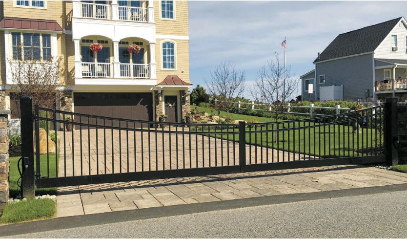 large home with Fence gate design on driveway