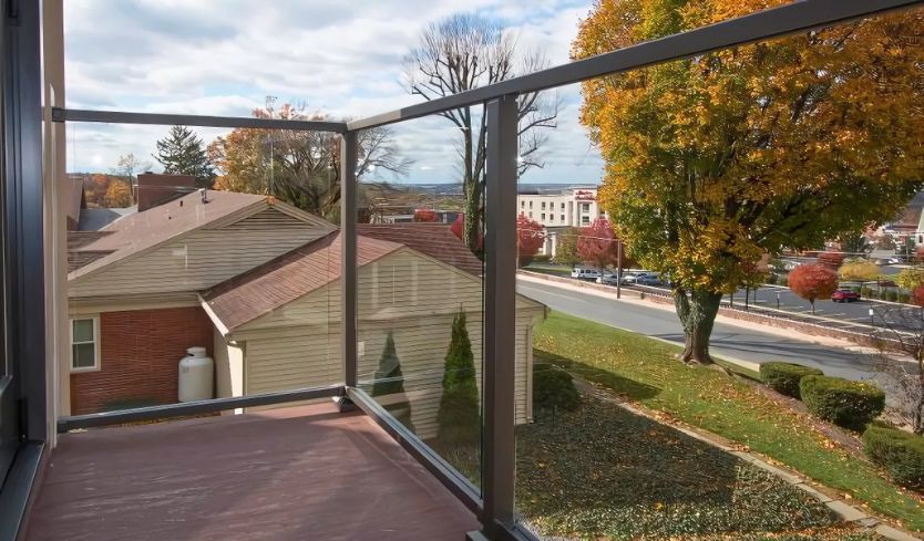 Glass railing systems balcony overlooking neighborhood in autumn 